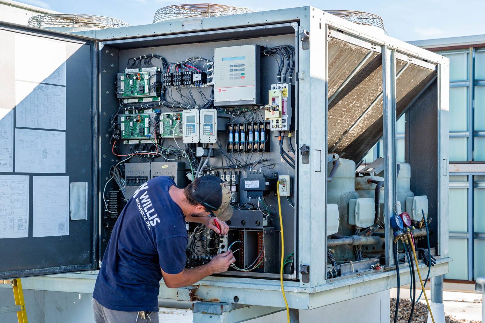 Willis Mechanical technicians working on commercial equipment outdoors